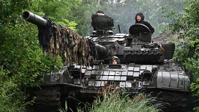 Ukrainian servicemen check their T-72 tank at a position in the Donetsk region, amid the Russian invasion of Ukraine. Picture: AFP