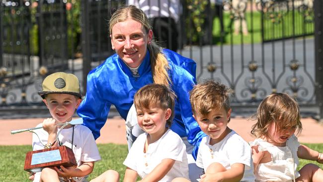 Jamie Kah with Dean Holland’s children after they presented her with the Dean Holland Trophy following her Newmarket Handicap win at Flemington. Picture: Vince Caligiuri/Getty Images