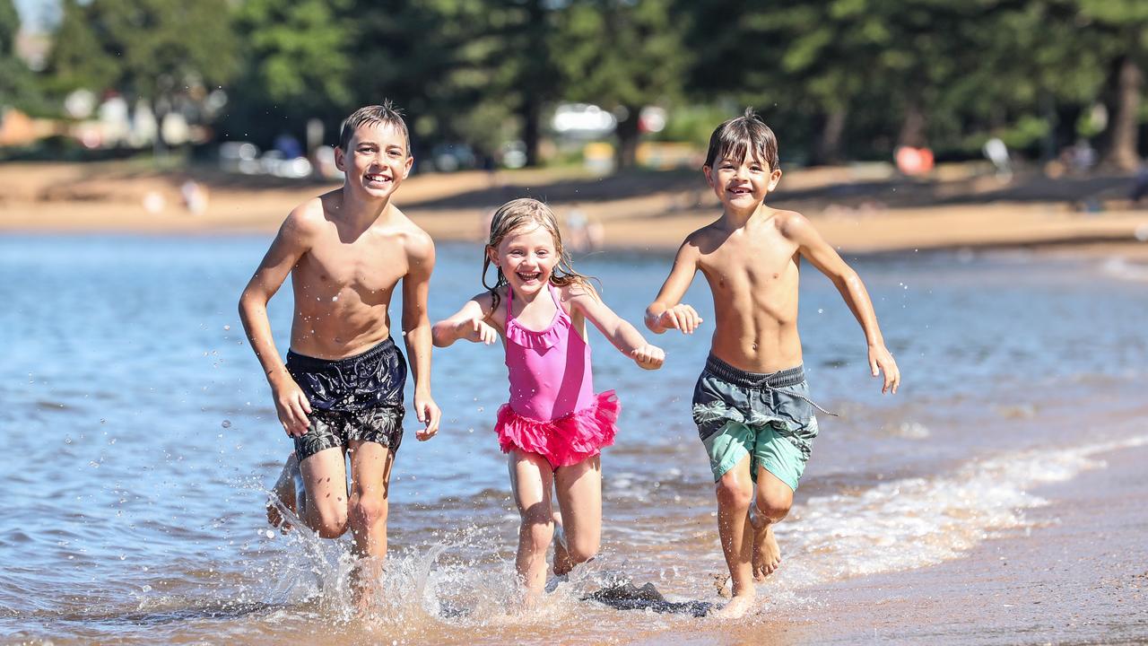 Siblings Caiden, 11, Isla, 4 and Jaxx Eggins, 7 of Murrumba Downs have fun at Scarborough Beach as Queensland’s golden glow continues after Easter. Picture: Zak Simmonds