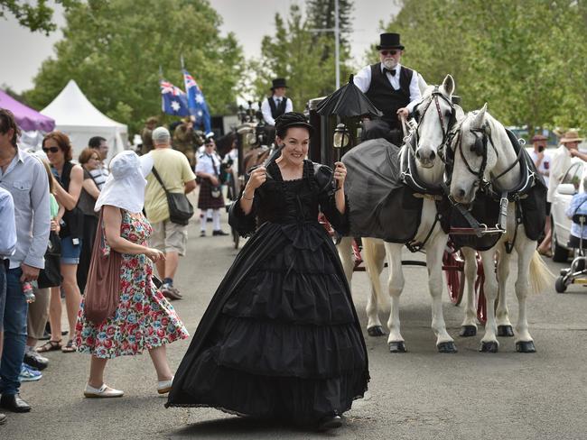 A woman dressed in Victorian clothing performs in a parade at Rookwood. Picture: AFP/Peter Parks