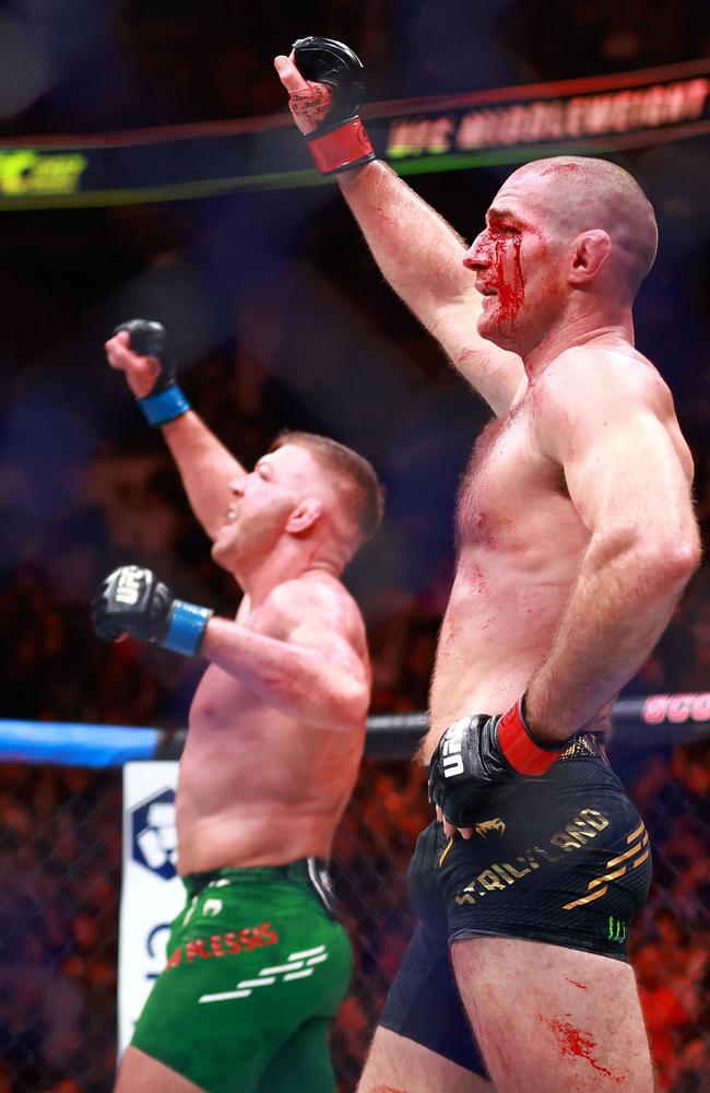 Both men raise their arm after teh fight. Picture: Vaughn Ridley/GETTY