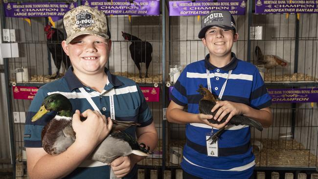 Eli Sippel (left) holding his Junior Champion waterfowl and Ryleigh Sippel with his Junior Champion batam hardfeather at the Toowoomba Royal Show, Thursday, April 18, 2024. Picture: Kevin Farmer