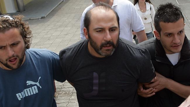 Tony Mokbel being escorted by Greek police.