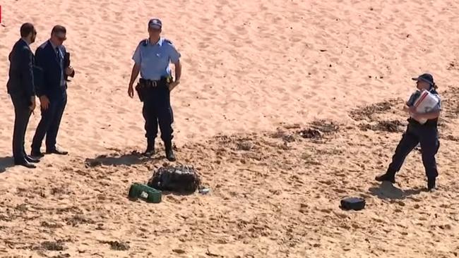 Police investigating the scene on Malabar beach yesterday. Picture: 7News