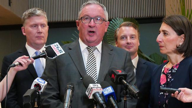 New South Wales Health Minister Brad Hazzard speaks to the media as Premier Gladys Berejiklian looks on. Photo: AAP/Andrew Leeson.