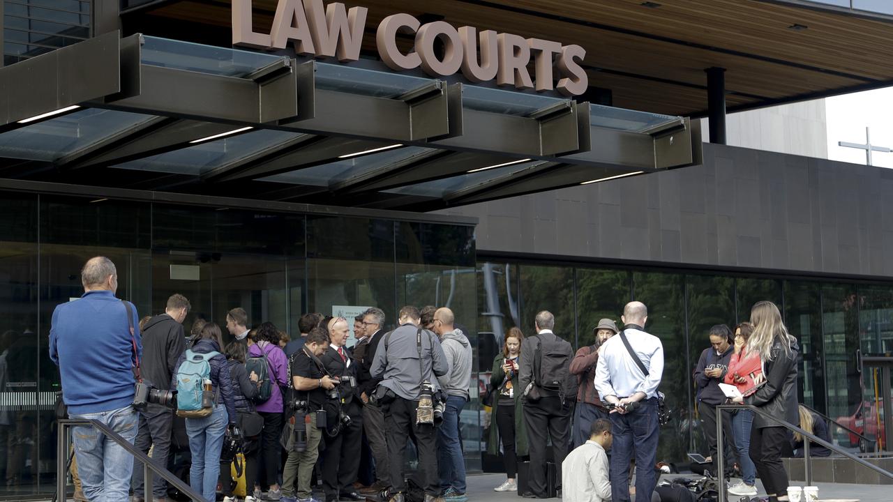 Members of the media wait outside the district court building in Christchurch. Picture: AP