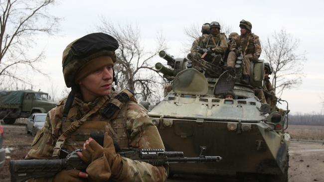 Ukrainian servicemen get ready to repel an attack in Ukraine's Lugansk region.