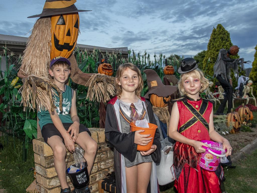 (from left) Aiden Walker, Indi Lewis and Milly Walker visit the Halloween display of Jo Philp. Monday, October 31, 2022. Picture: Nev Madsen.