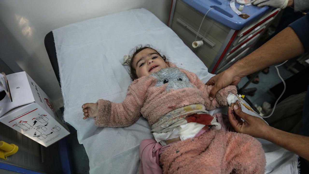 A Palestinian girl is injured by an Israeli airstrike. Picture: Ahmad Hasaballah