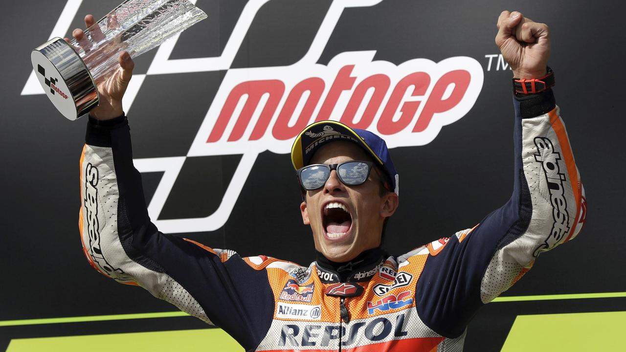 Marquez celebrates on the podium after winning the MotoGP race in Brno.