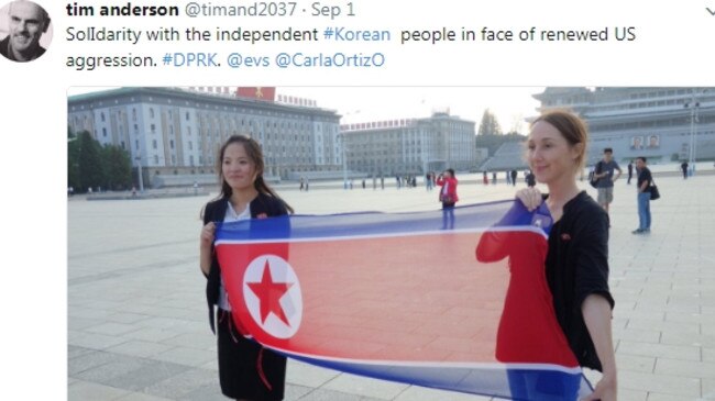 One of Mr Anderson’s North Korea happy snaps, with Ms Bartlett holding up the North Korean flag.