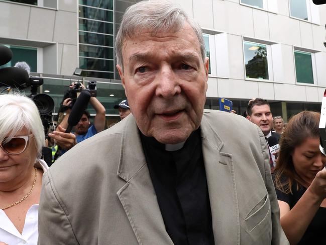 (FILES) In this file photo taken on February 26, 2019 Cardinal George Pell (C) leaves the County Court of Victoria court after prosecutors decided not to proceed with a second trial on alleged historical child sexual offences in Melbourne. - Disgraced Australian Cardinal Pell was sentenced to six years in jail for child sex crimes in a Melbourne court on March 13, 2019, with a non-parole period of three years and eight months. (Photo by Asanka Brendon Ratnayake / AFP)