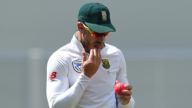 South African captain Faf du Plessis takes saliva to shine the ball. (AAP Image/Dave Hunt)