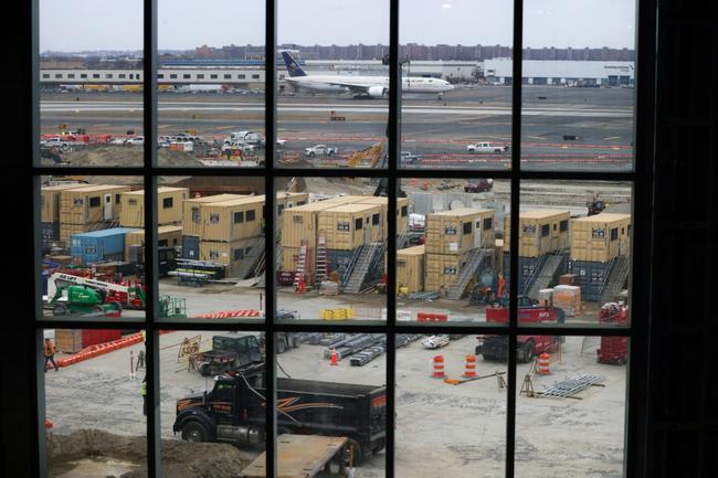 The terminal is strikingly wide and narrow, optimizing the limited space available between runways and the airport's Air Train people mover