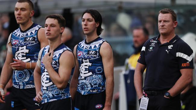 Blues players and Michael Voss watch on. Picture: Michael Klein