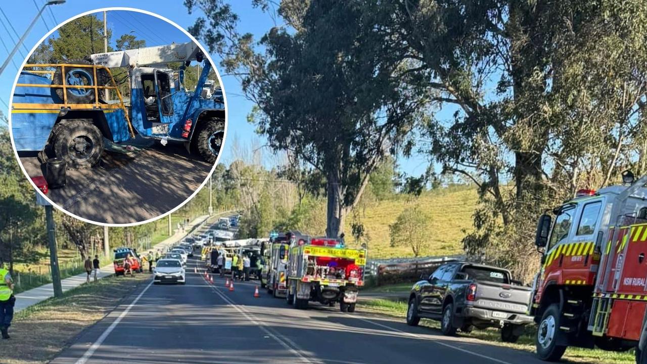 Man hospitalised after truck carrying crane rolls down hill