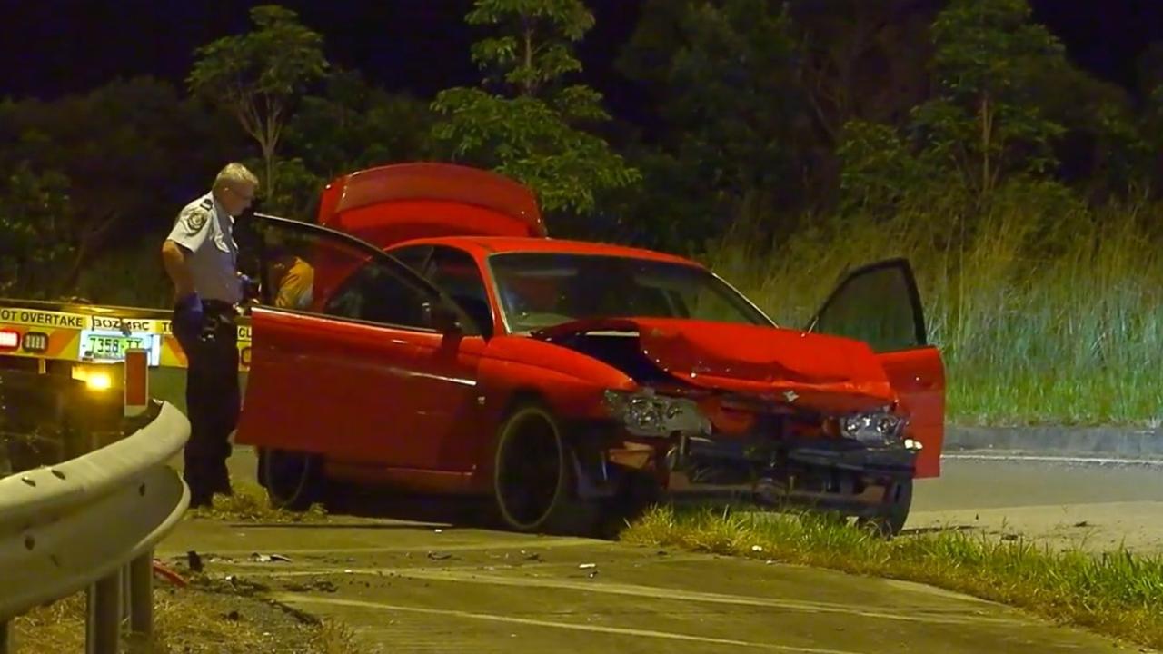 Police investigate a crash that happened in an exit lane from the Pacific Highway at Moonee Beach on March 9, 2022.