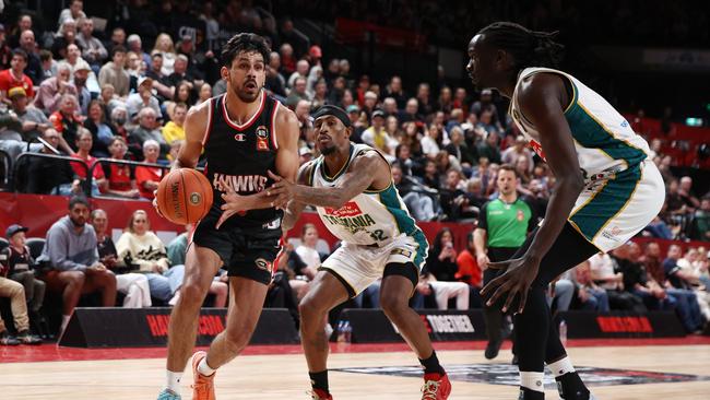 WOLLONGONG, AUSTRALIA – OCTOBER 12: William Hickey of the Hawks dribbles the ball under pressure from Craig Sword of the JackJumpers during the round four NBL match between Illawarra Hawks and Tasmania JackJumpers at WIN Entertainment Centre on October 12, 2024 in Wollongong, Australia. (Photo by Jason McCawley/Getty Images)