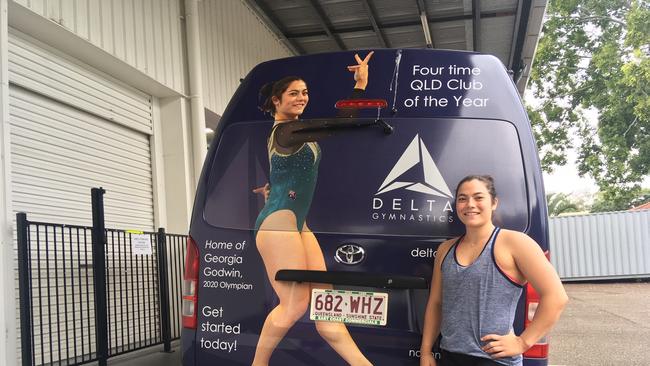 Future Olympic gymnast Georgia Godwin in front of the Delta Gymnastic’s bus.