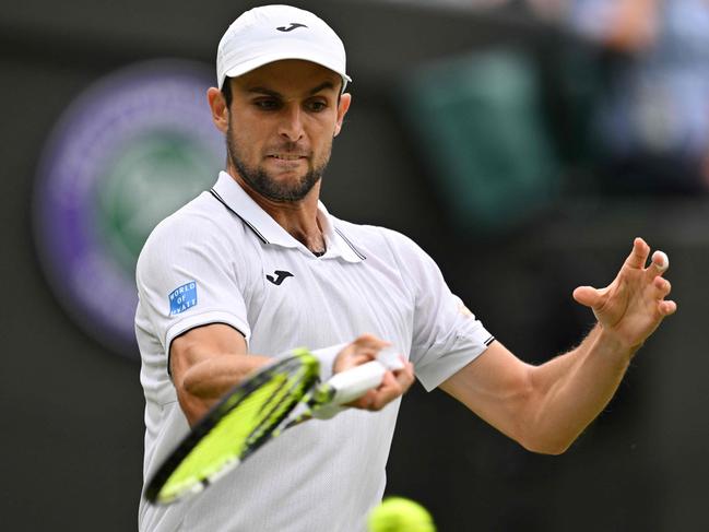 Australia's Aleksander Vukic returns against Spain's Carlos Alcaraz during their men's singles second round tennis match on the third day of the 2024 Wimbledon Championships at The All England Lawn Tennis and Croquet Club in Wimbledon, southwest London, on July 3, 2024. (Photo by ANDREJ ISAKOVIC / AFP) / RESTRICTED TO EDITORIAL USE