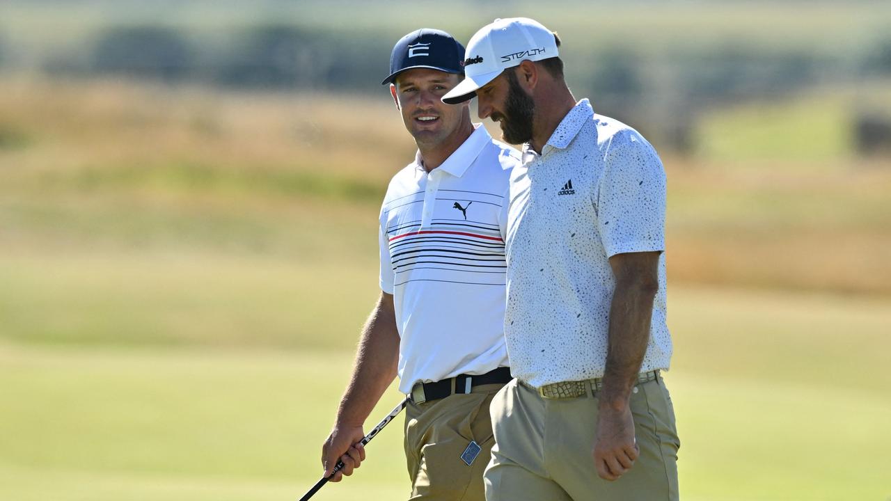 US golfer Bryson DeChambeau (L) and US golfer Dustin Johnson (R) chat during a practice round for The 150th British Open Golf Championship on The Old Course at St Andrews in Scotland on July 10, 2022. (Photo by Glyn KIRK / AFP) / RESTRICTED TO EDITORIAL USE