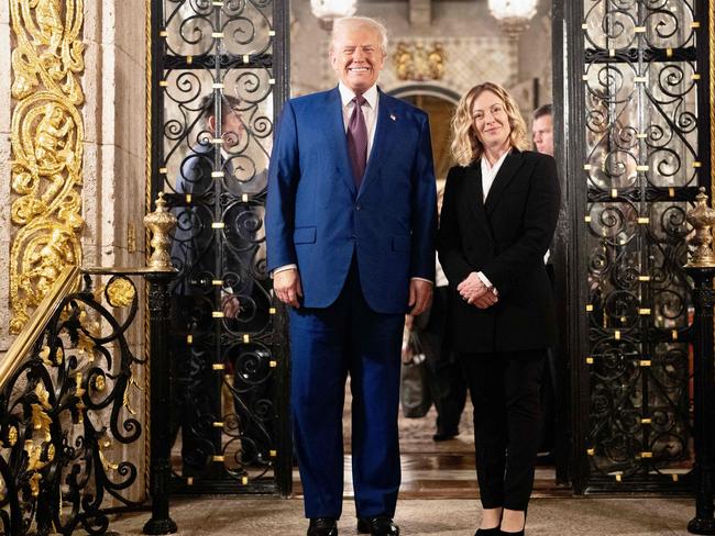 This handout picture released by the Palazzo Chigi press office on January 5, 2025 shows Italy's Prime Minister Giorgia Meloni posing with US President-elect Donald Trump at his Mar-A-Lago Club on January 4, 2025 in Palm Beach, Florida. (Photo by Filippo ATTILI / Palazzo Chigi press office / AFP) / RESTRICTED TO EDITORIAL USE - MANDATORY CREDIT "AFP PHOTO /PALAZZO CHIGI PRESS OFFICE" - NO MARKETING NO ADVERTISING CAMPAIGNS - DISTRIBUTED AS A SERVICE TO CLIENTS