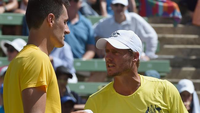 (FILES) In this file photograph taken on March 4, 2016, Australia's team captain Lleyton Hewitt (R) encourages compatriot Bernard Tomic (L) between games against Jack Sock of the US during their men's singles match at the World Group first round Davis Cup tennis tournament at Kooyong in Melbourne. - Lleyton Hewitt accused Bernard Tomic of blackmail and physical threats against him and his family in explosive allegations on January 17, 2019, as Australian tennis plunged to new lows. The veteran two-time Grand Slam champion said the firebrand player would never again feature in Davis Cup while he captained the Australian team. (Photo by Paul CROCK / AFP) / IMAGE RESTRICTED TO EDITORIAL USE - STRICTLY NO COMMERCIAL USE