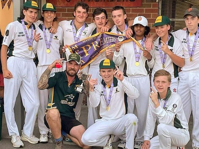 Coach Chris Moloney and the Carrum Downs under 16s celebrate a premiership.