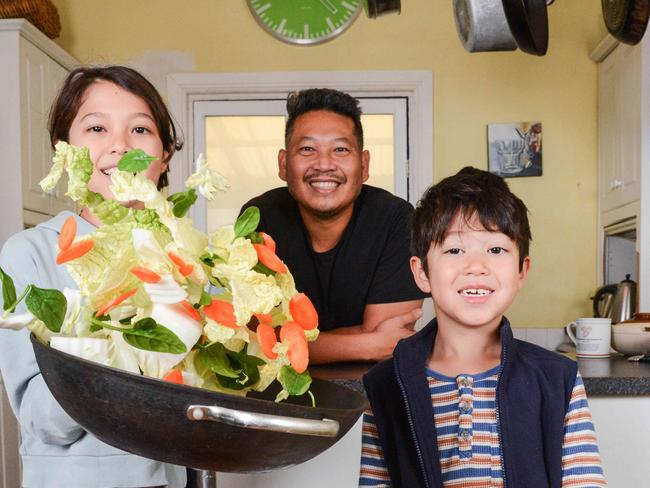 JUNE 10, 2022: Soi 38 chef Terry Intarakhamhaeng cooking Wombok with his kids Adelaide 10yo and Bertie 7 in their kitchen. PHOTO:  Brenton Edwards