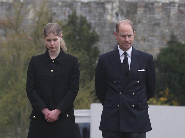 Britain's Prince Edward, Earl of Wessex, and his daughter Britain's Lady Louise Windsor view flowers outside St George's Chapel, at Windsor Castle in Windsor, west of London, on April 16, 2021, following the April 9 death of Britain's Prince Philip, Duke of Edinburgh, at the age of 99. - Final preparations continued Friday in Britain for the funeral of Queen Elizabeth's husband Prince Philip, as it emerged that his grandsons Prince William and Prince Harry will not be side by side as the family walks into the chapel. (Photo by Steve Parsons / POOL / AFP)