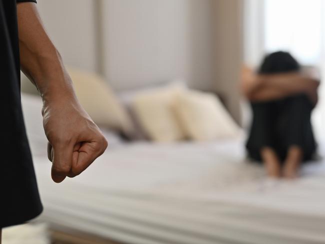 istock generic:  woman, abuse, DV, domestic violence, harassment, sexual harassment.   Selective focus on the fist male with crying man sits on a bed as the background, Violence, Love and relationships, Gay couple, sexual harassment concept. . Picture: istock