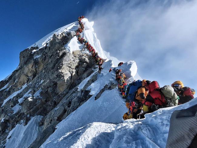 REVALIDATING - MANDATORY CREDIT REQUIRED: “@nimsdai Project Possible” This handout photo taken on May 22, 2019 and released by @nimsdai Project Possible shows heavy traffic of mountain climbers lining up to stand at the summit of Mount Everest. - Many teams had to line up for hours on May 22 to reach the summit, risking frostbites and altitude sickness, as a rush of climbers marked one of the busiest days on the world's highest mountain. (Photo by Handout / @nimsdai Project Possible / AFP) / RESTRICTED TO EDITORIAL USE - MANDATORY CREDIT "AFP PHOTO / @NIMSDAI PROJECT POSSIBLE" - NO MARKETING NO ADVERTISING CAMPAIGNS - DISTRIBUTED AS A SERVICE TO CLIENTS == NO ARCHIVE