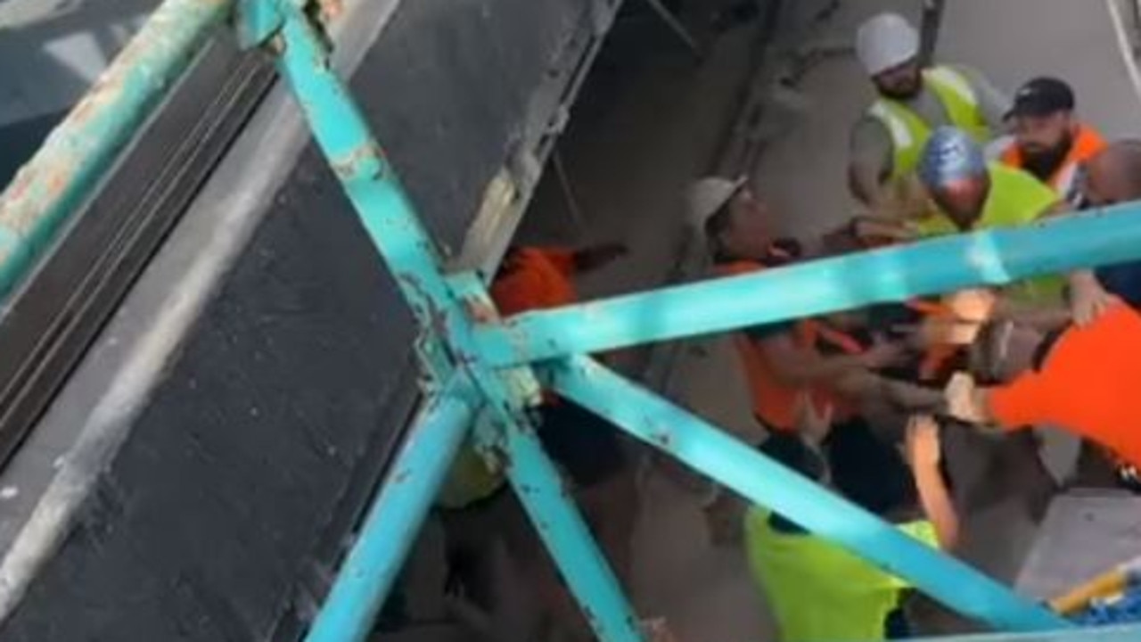 One worker throws punches at the man who was wielding the helmet.