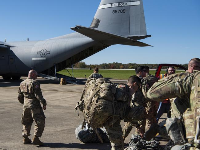 This Oct. 29, 2018 photo provided by the U.S. Air Force shows deployers from Headquarters Company, 89th Military Police Brigade, Task Force Griffin get ready to board a C-130J Super Hercules from Little Rock, Arkansas, at Fort Knox, Kentucky, in support of Operation Faithful Patriot. The Trump administration on Monday, Oct. 29, 2018, announced plans to deploy 5,200 active duty troops, double the 2,000 who are in Syria fighting the Islamic State group, to the border to help stave off the caravans. The main caravan, still in southern Mexico, was continuing to melt away, from the original 7,000 to about 4,000, as a smaller group apparently hoped to join it. (Airman 1st Class Zoe M. Wockenfuss/U.S. Air Force via AP)