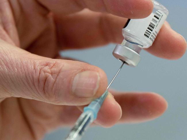 Medical personnel prepares a syringe with the Pfizer-BioNTech vaccine against Covid-19 at the pharmacy of the vaccination center at the Robert Bosch hospital in Stuttgart, southern Germany, on February 12, 2021. (Photo by THOMAS KIENZLE / AFP)