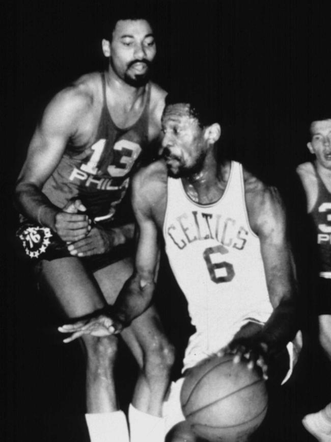 Bill Russell drives past his great rival Wilt Chamberlain.