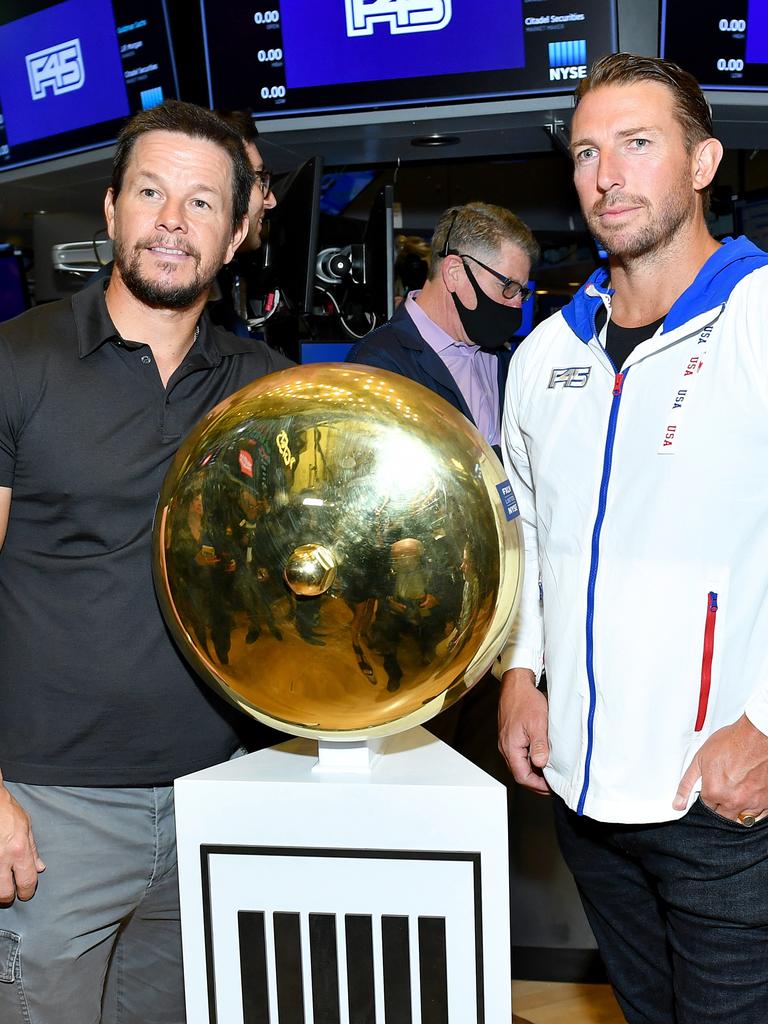 F45 Founder and CEO Adam Gilchrist with company investor Mark Wahlberg posing on the trading floor of the New York Stock Exchange. Picture: Noam Galai/Getty Images