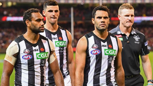 Travis Varcoe, Scott Pendlebury, Daniel Wells walk off with coach Nathan Buckley after Collingwood’s loss to Essendon. Picture: Getty Images