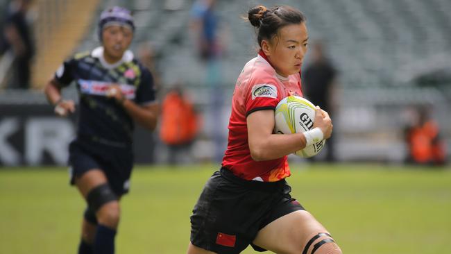 China’s Chen Keyi runs to score a try against Japan at the Asia sevens qualifiers.
