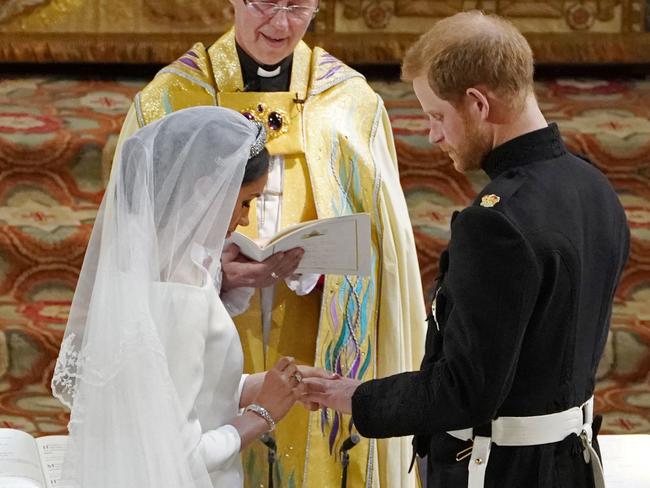 Prince Harry Meghan Markle and Britain's Prince Harry, Duke of Sussex exchange rings. Picture: AFP