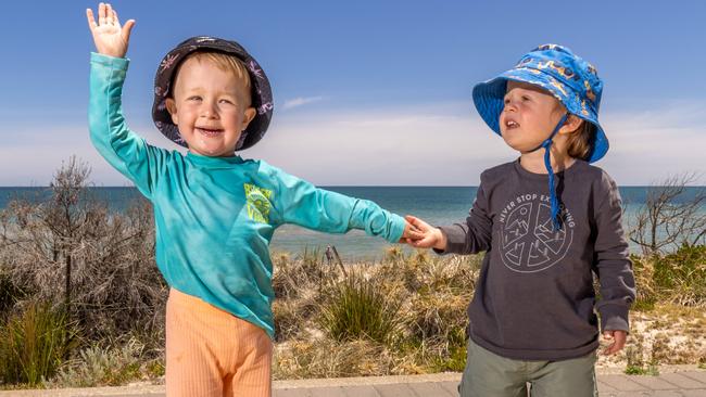 Best mates, Remi and Sonny, both 2, walking down to the beach at Henley. Picture: Ben Clark