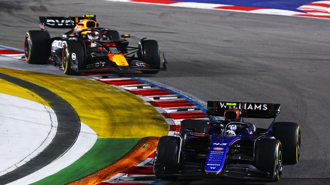 Franco Colapinto defends from Sergio Perez in Singapore. (Photo by Mark Thompson/Getty Images)