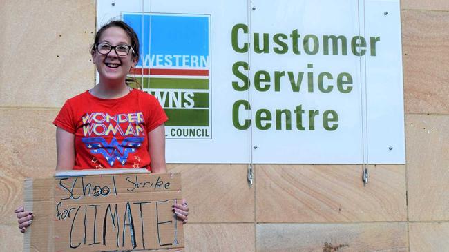 GO GREEN: Instead of enjoying her last day of the terms at her school's "Celebration Day", 12-year-old Ariel Ehlers from Chinchilla is taking a stand against climate change and protesting for climate action outside the Western Downs. Picture: Kate McCormack