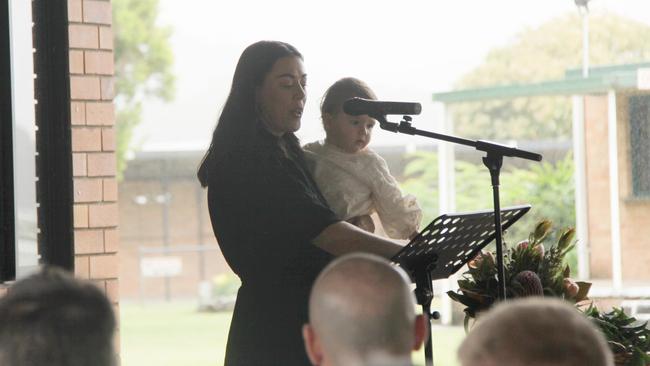 MY CAMERON: His partner Tara holds daughter Lennie as she speaks from the heart to more than 500 people about her love for Cameron Rodney Hyde, 32, who passed away from cancer. Photo: Alison Paterson