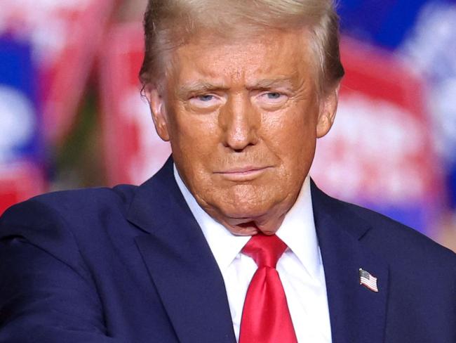 TOPSHOT - Former US President and Republican presidential candidate Donald Trump gestures during a campaign rally at PPG Paints Arena in Pittsburgh, Pennsylvania on November 4, 2024. (Photo by CHARLY TRIBALLEAU / AFP)