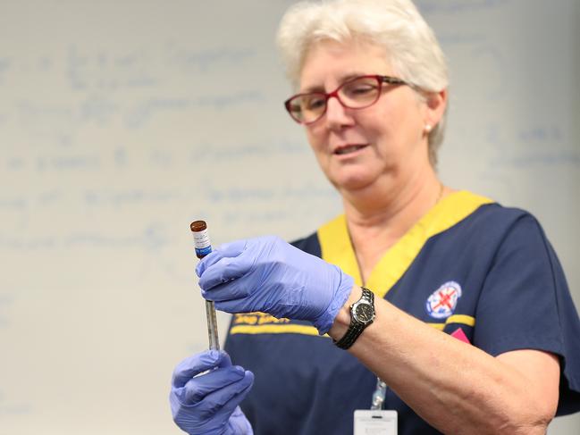 A clinical staff member draws vaccine from a vial in the trial. Picture: Getty