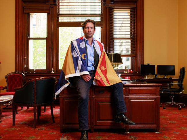 Sydney City Councillor Lyndon Gannon with the official City of Sydney flag. Council staff confiscated the flag from his office after a council meeting last month. Picture: Justin Lloyd.