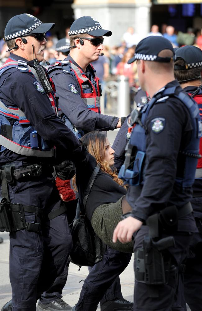 Police move in to remove vegan protestors who had been blocking the intersection of Flinders and Swanston Street Melbourne in support of animal rights. Picture: Andrew Henshaw