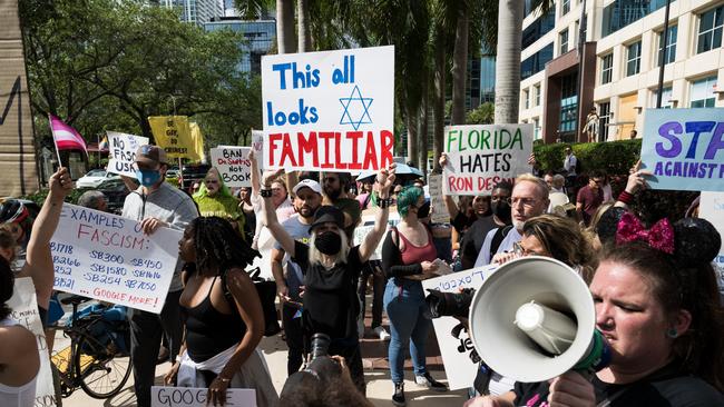 Protesters march while the Democratic National Committee's mobile billboard drives through the streets of Miami in Florida on the day of Ron DeSantis’s campaign launch. Picture: Getty Images