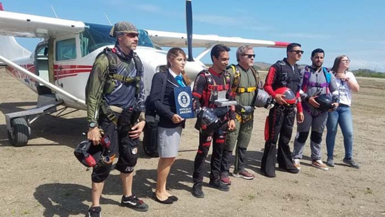 The paratroopers and pilot receive their official Guinness World Record certificate after the jump. Picture: Guinness World Records